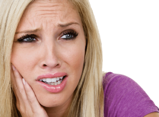 A woman with long blonde hair and a purple shirt holds her hand to her cheek, looking distressed or in pain, possibly experiencing a toothache or discomfort.