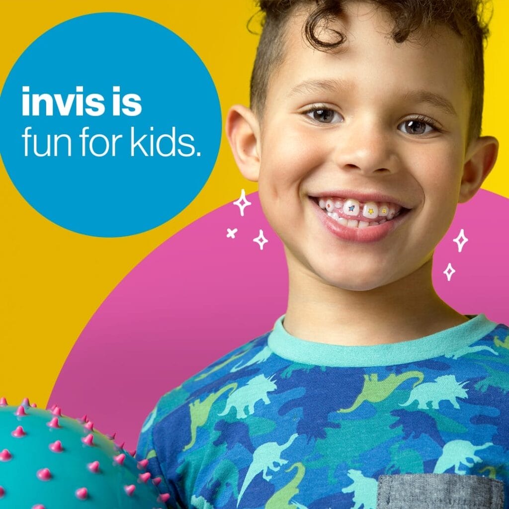 Smiling child with curly hair and colorful dinosaur shirt holds a blue spiky ball. Text on the image reads, "invis is fun for kids." Bright yellow and pink background with sparkles near the child's mouth.