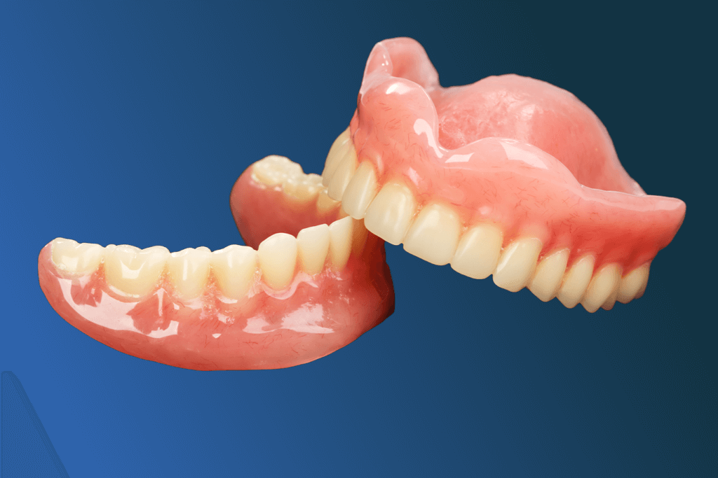 A set of upper and lower dentures with pink gums and white artificial teeth is shown against a blue gradient background.